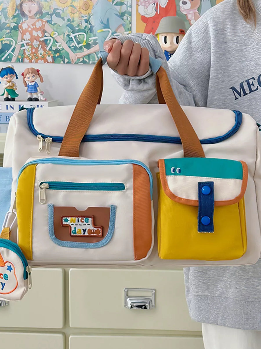 Vibrant multi-pocket nylon travel bag with color block details and "Nice day" patch.