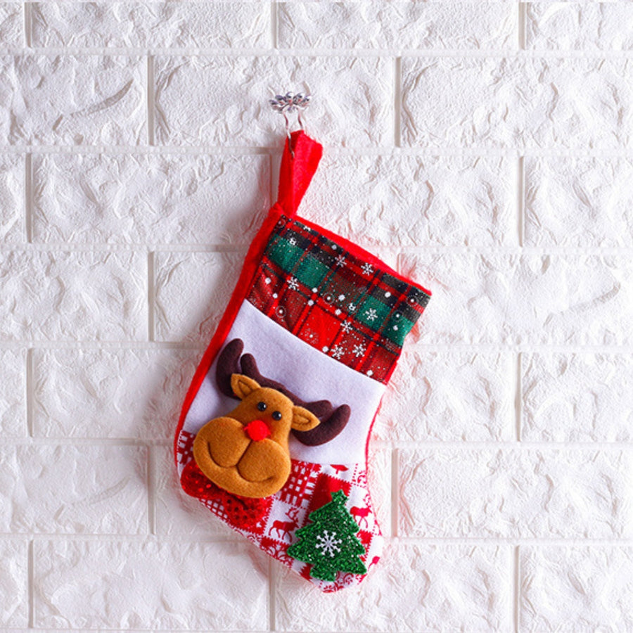 Christmas stocking with reindeer applique and plaid cuff.