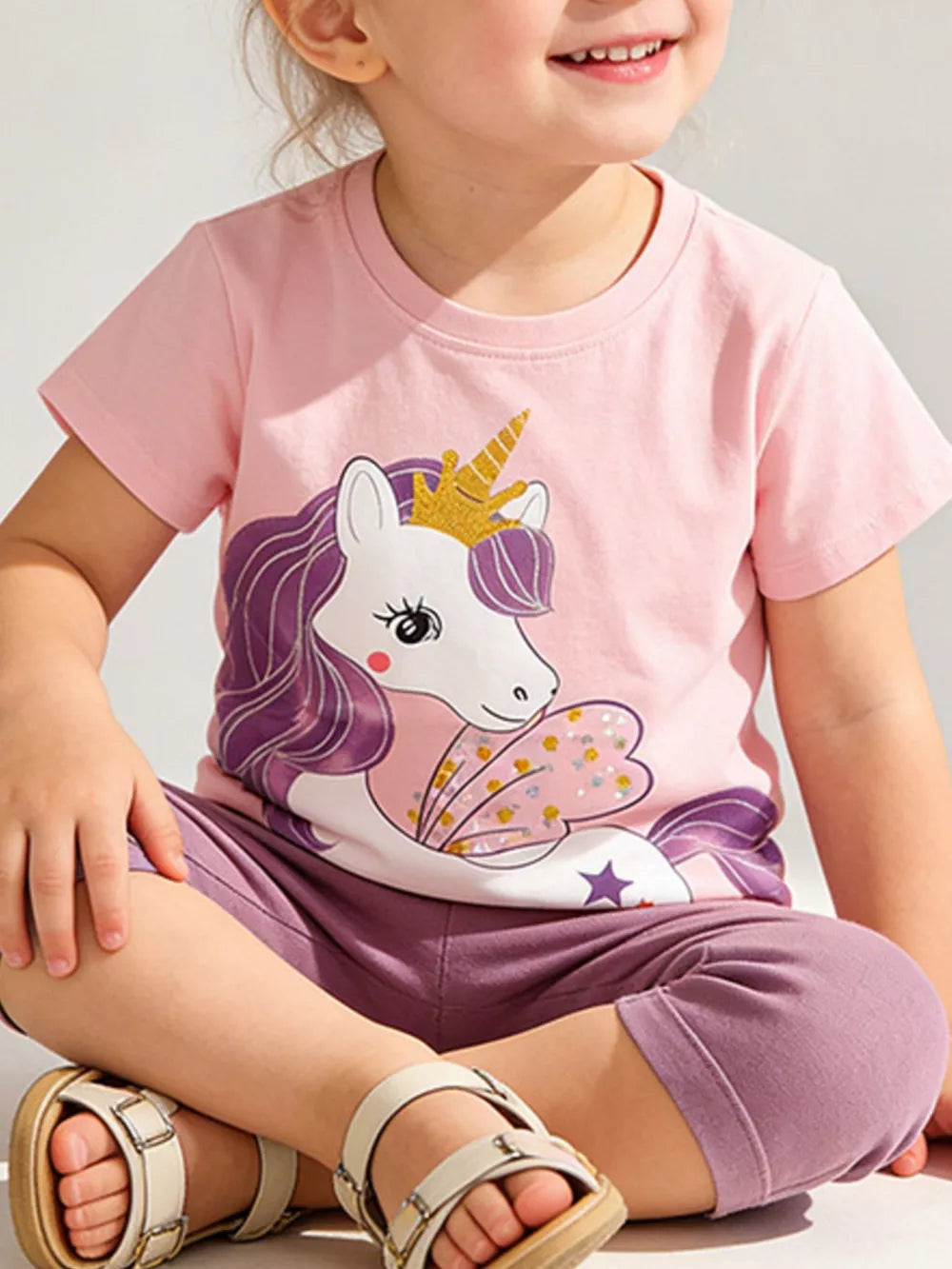 Pink cotton toddler t-shirt with a magical unicorn graphic, short sleeves, and crew neck.