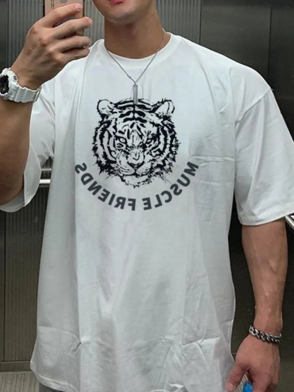 White oversized tee with a black tiger graphic and reversed text.