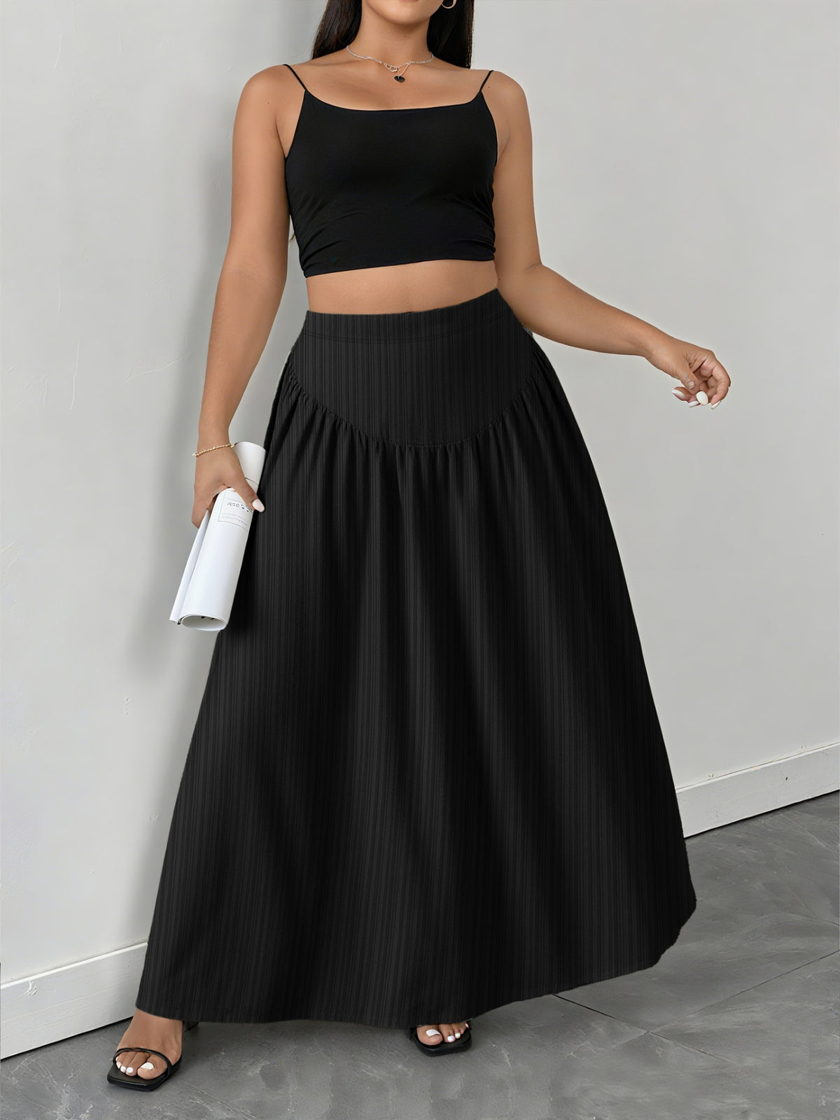 Black a-line maxi skirt with subtle vertical stripes and a gathered waist.