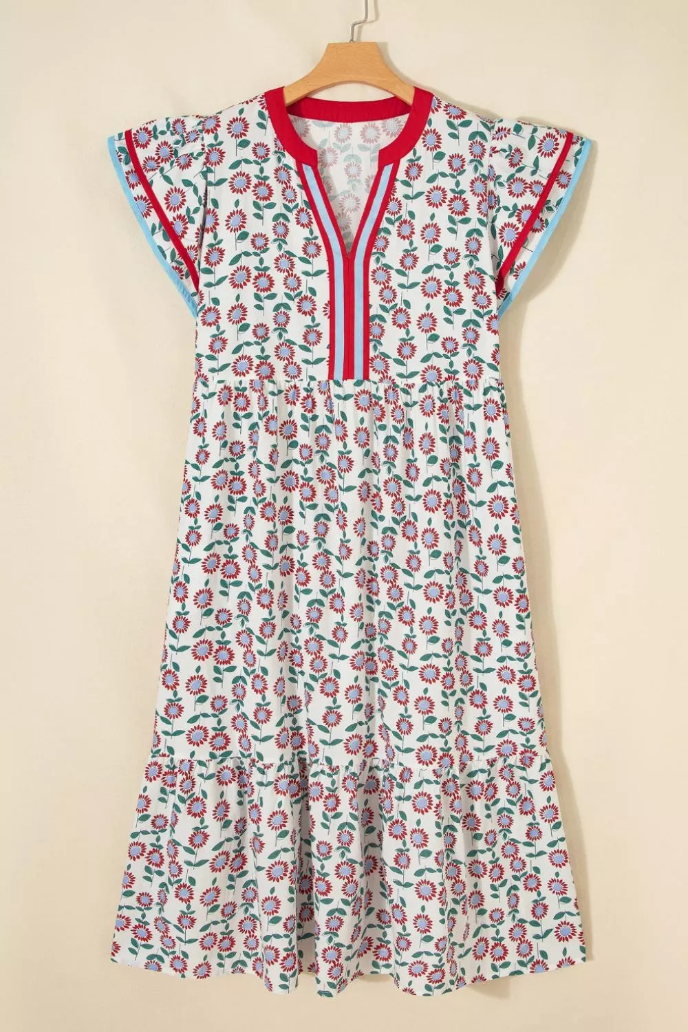 Vibrant floral midi dress with tiered skirt, V-neck, and short sleeves.