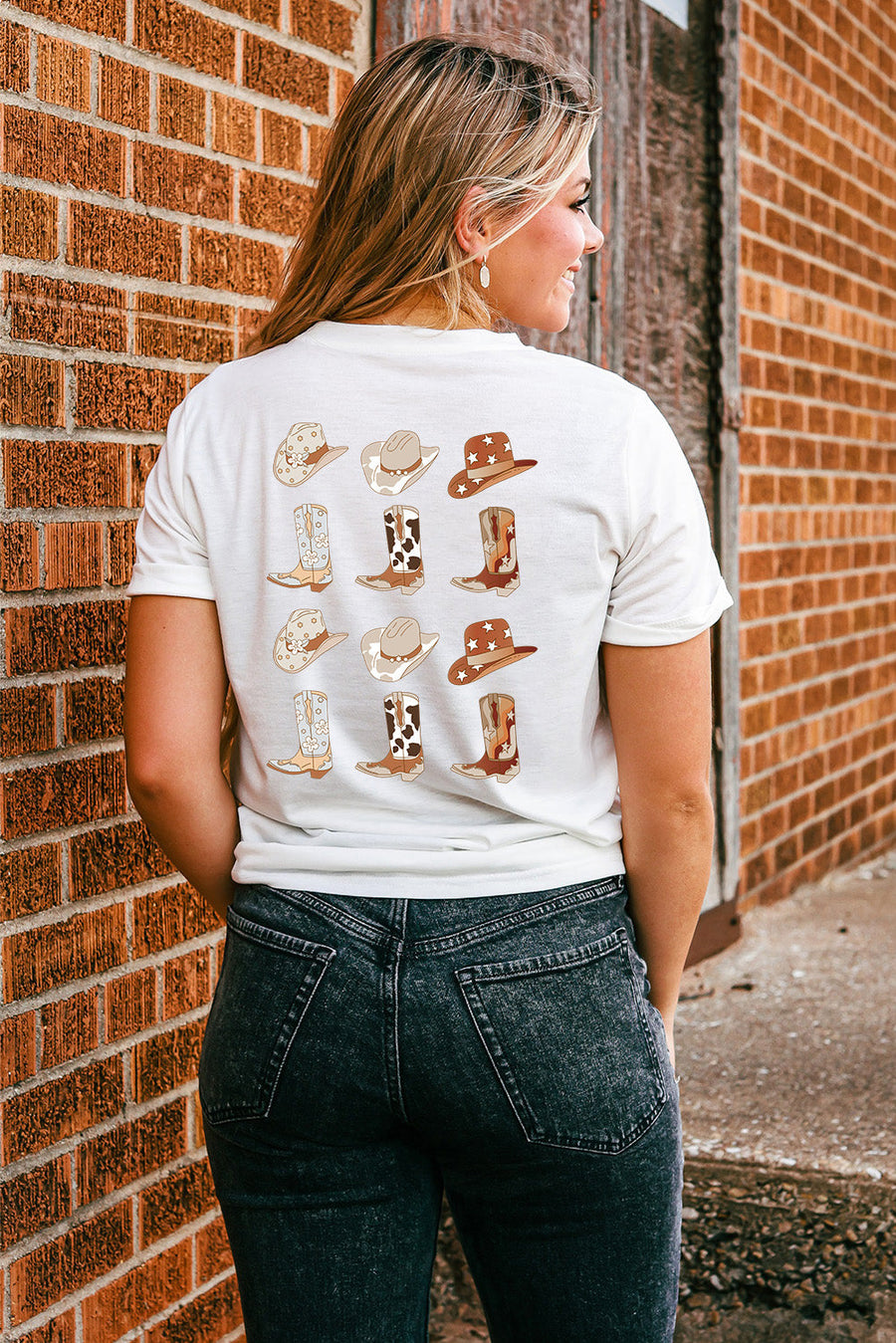 White graphic tee with cowboy boots and hats pattern
