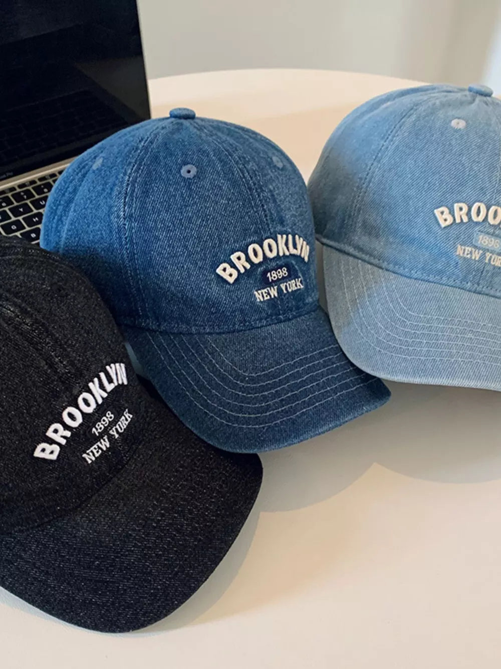 Brooklyn letter-embroidered baseball caps in black, dark blue, and light blue denim.