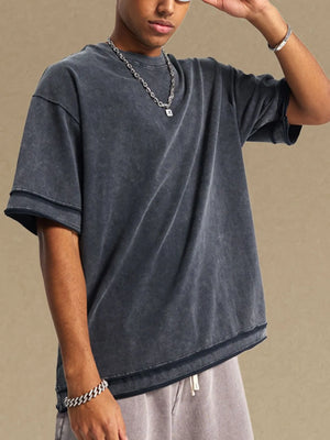 Washed cotton t-shirt in dark gray with raw edge details and a relaxed fit.