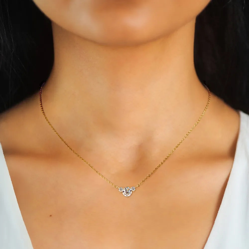 Gold necklace with a celestial trio diamond pendant.
