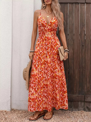 Maxi dress with abstract print, V-neck, smocked waist, and spaghetti straps.
