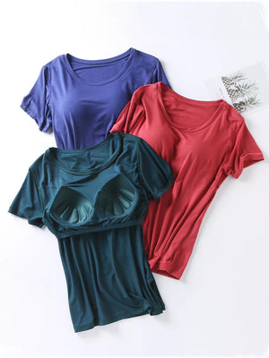 Three short-sleeve t-shirts in Space Blue, Windsor Red, and Fini Green, one with built-in bra cups.