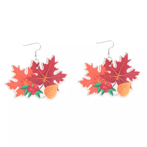 Playful Thanksgiving dangle earrings with red and orange maple leaves and red berries.