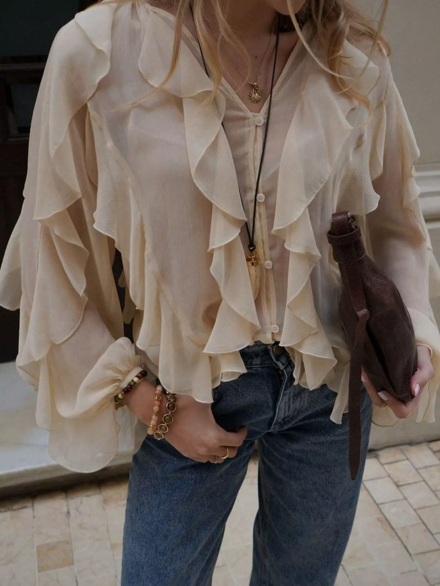 Beige sheer long-sleeve blouse with cascading ruffles and button front.