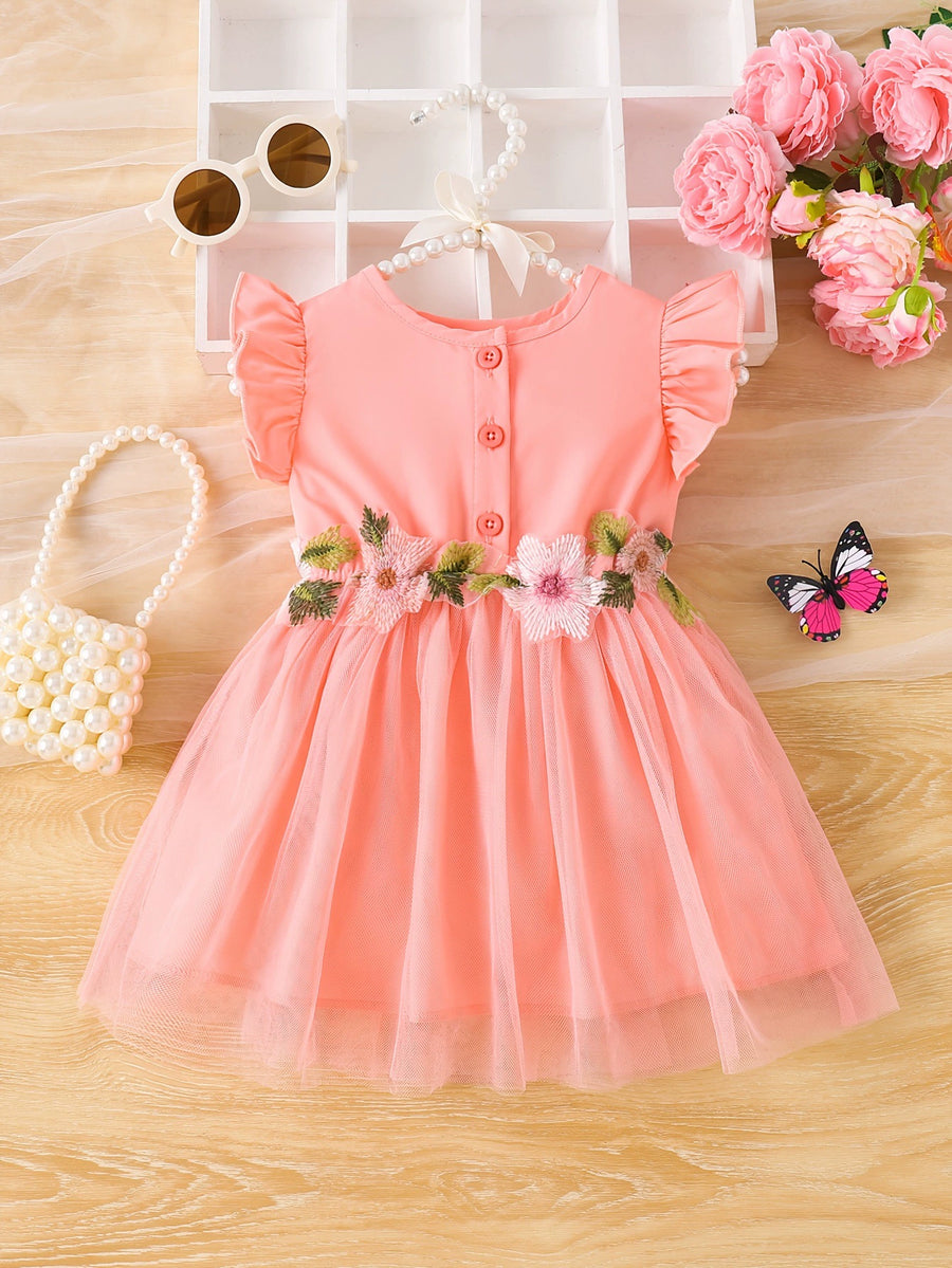 Baby girl watermelon pink tulle dress with floral appliqué and ruffle sleeves.