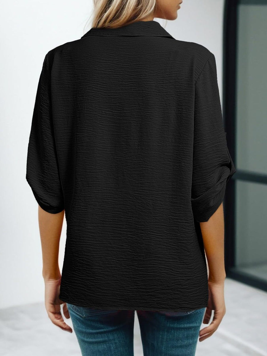 Black crinkled texture shirt with Johnny collar and cuffed short sleeves.