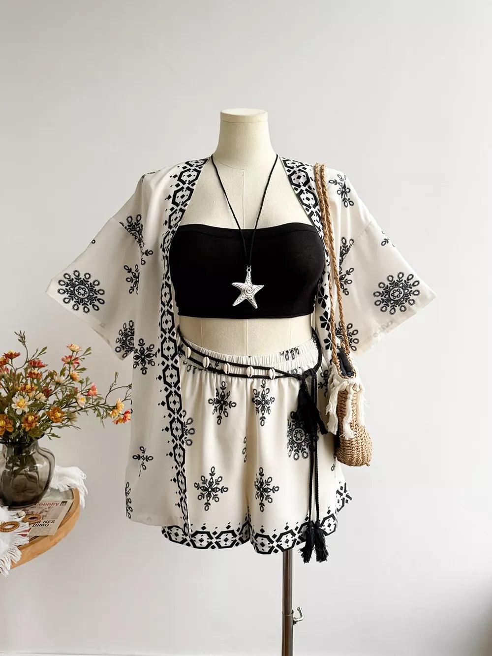White polyester kimono cardigan and shorts set with black tribal print, elastic waist shorts, tassel belt.