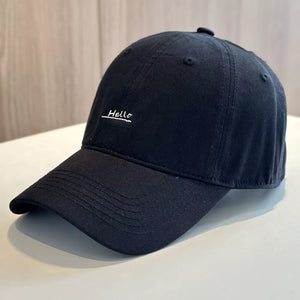 Black baseball cap with embroidered "Hello" detail