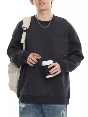 Dark gray sweatshirt with textured pocket and crew neck, casual men's style