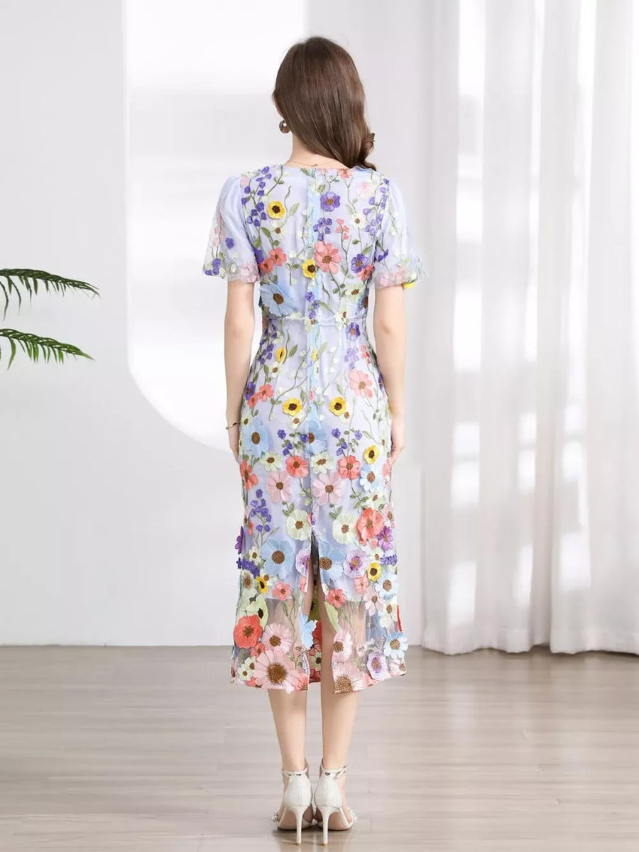 Sheath dress with short sleeves, a floral print, and a slit hem.