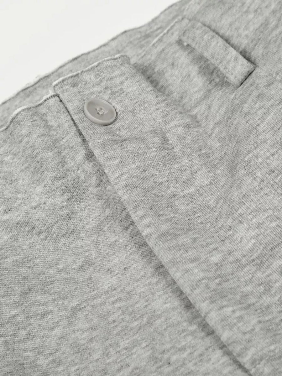 Men's gray sweatpants detail showing button closure and fabric texture.