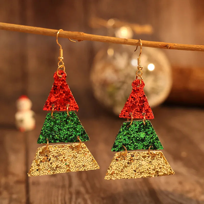 Festive glitter tiered Christmas tree earrings in red, green, and gold.