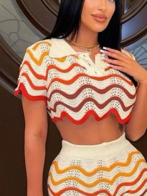 Crochet crop top with zigzag stripes in white, orange, red, and yellow.