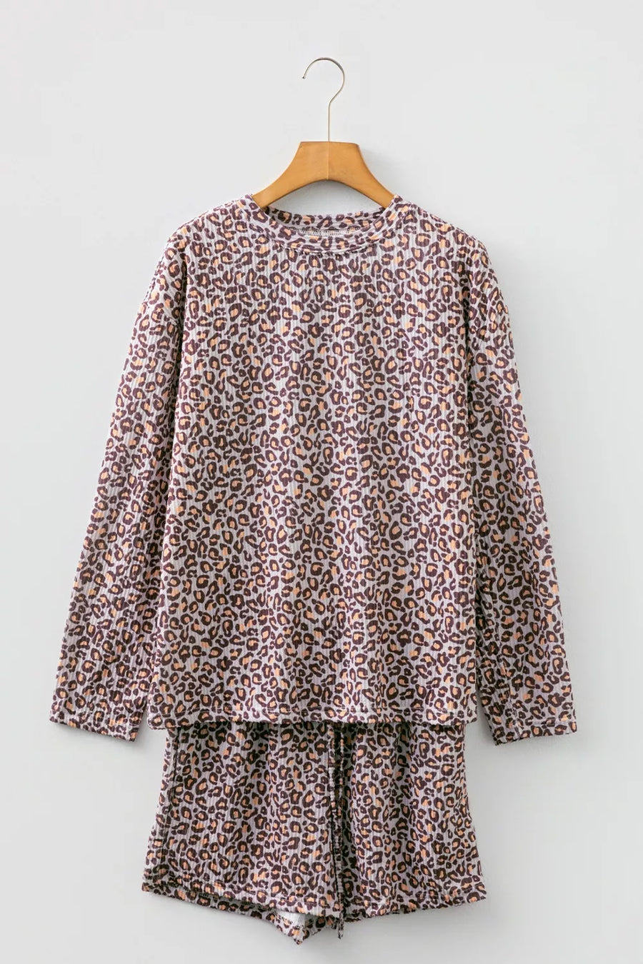 Leopard print ribbed loungewear set with long sleeve top and drawstring shorts.