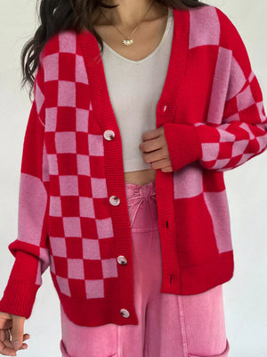 Checkerboard knit cardigan in deep rose with button front and ribbed cuffs.