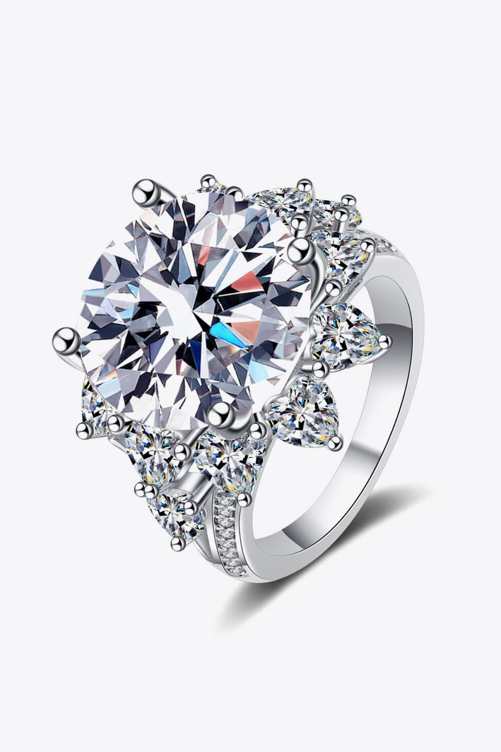 Silver moissanite cocktail ring with a large round center stone and pear-shaped accent stones.