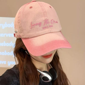 Blush pink cotton baseball cap with pink embroidery and gradient dye.