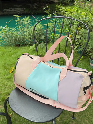 Vibrant pastel nylon duffle bag with color-blocked panels and pink straps.