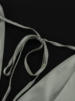 Satin camisole with adjustable tie straps in a light grey color.
