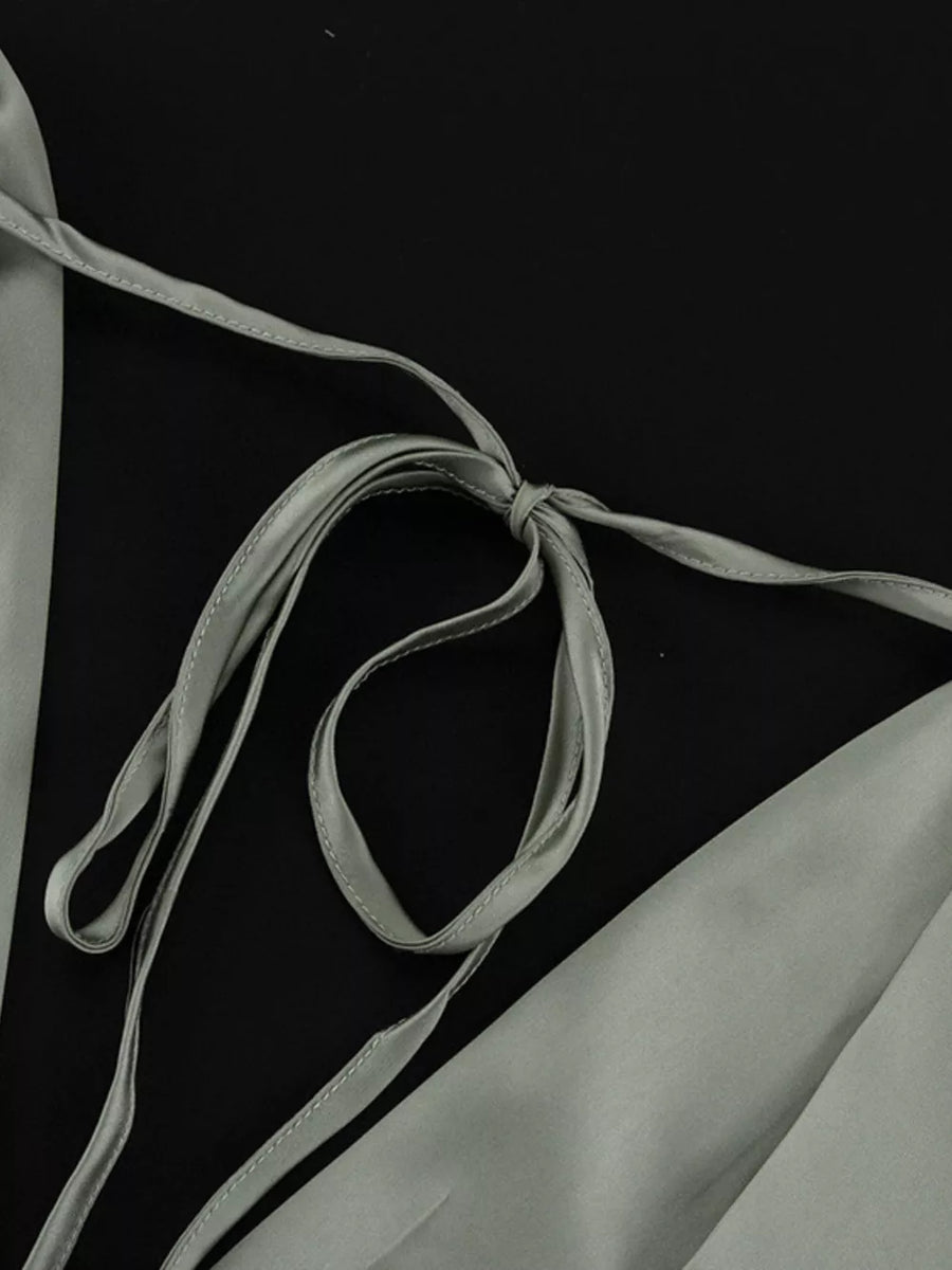 Satin camisole with adjustable tie straps in a light grey color.