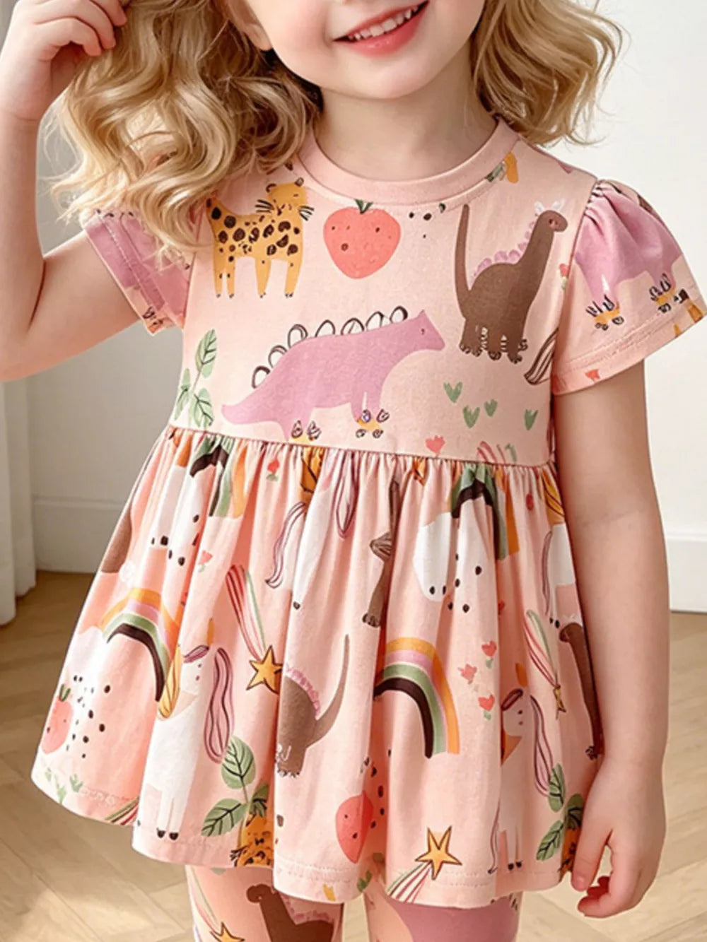 Pink cotton toddler dress with dinosaurs, rainbows, and unicorns.