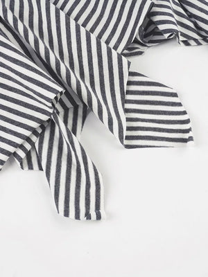 Asymmetrical hem mini skirt in black and white stripes with a soft knit fabric.
