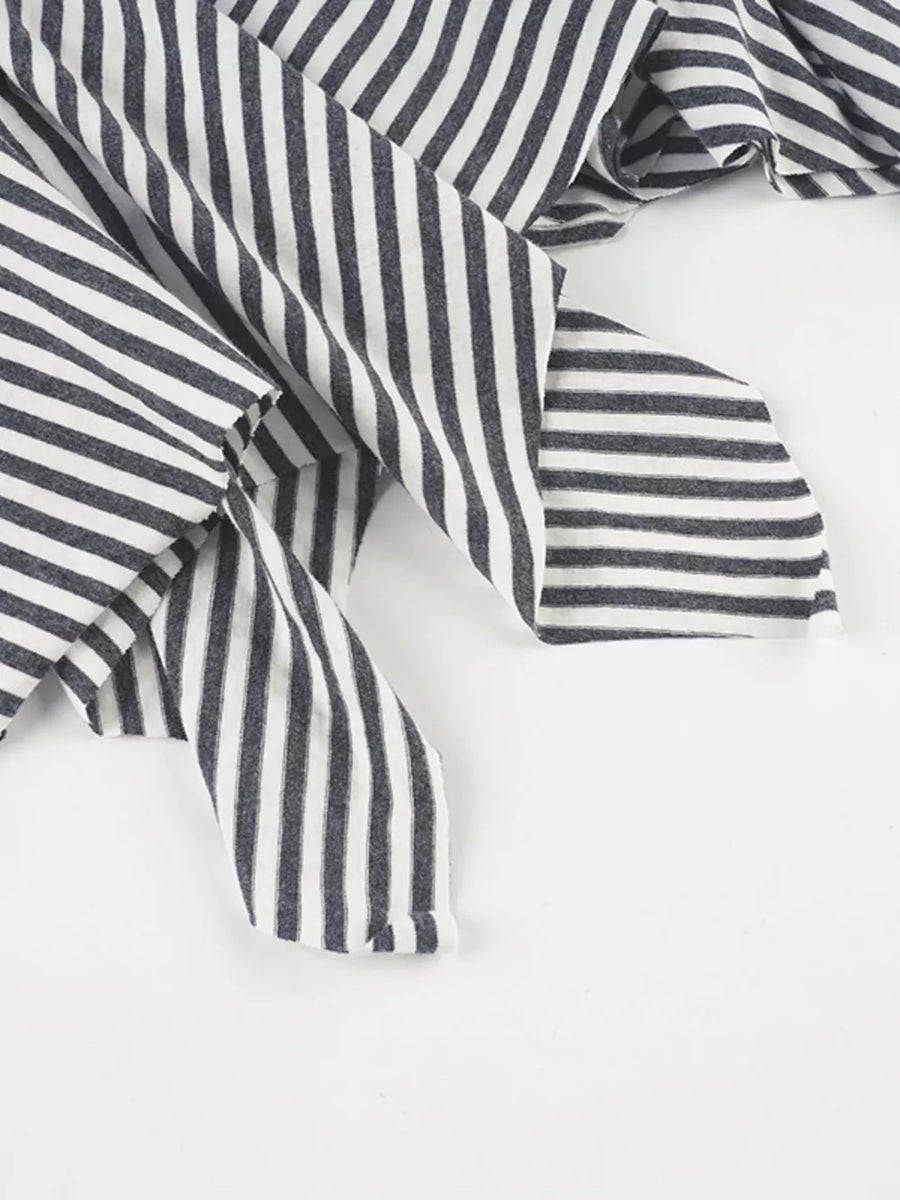 Asymmetrical hem mini skirt in black and white stripes with a soft knit fabric.