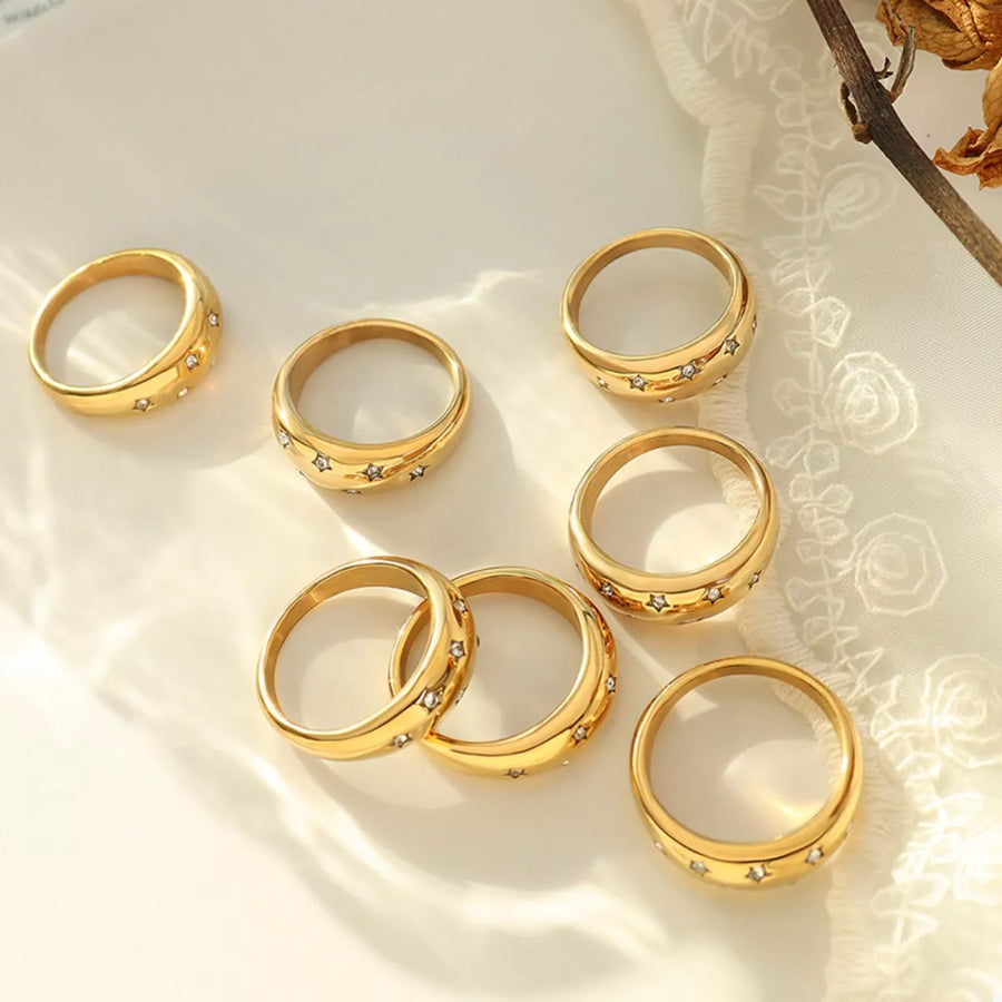 Gold rings with star-shaped zircon accents