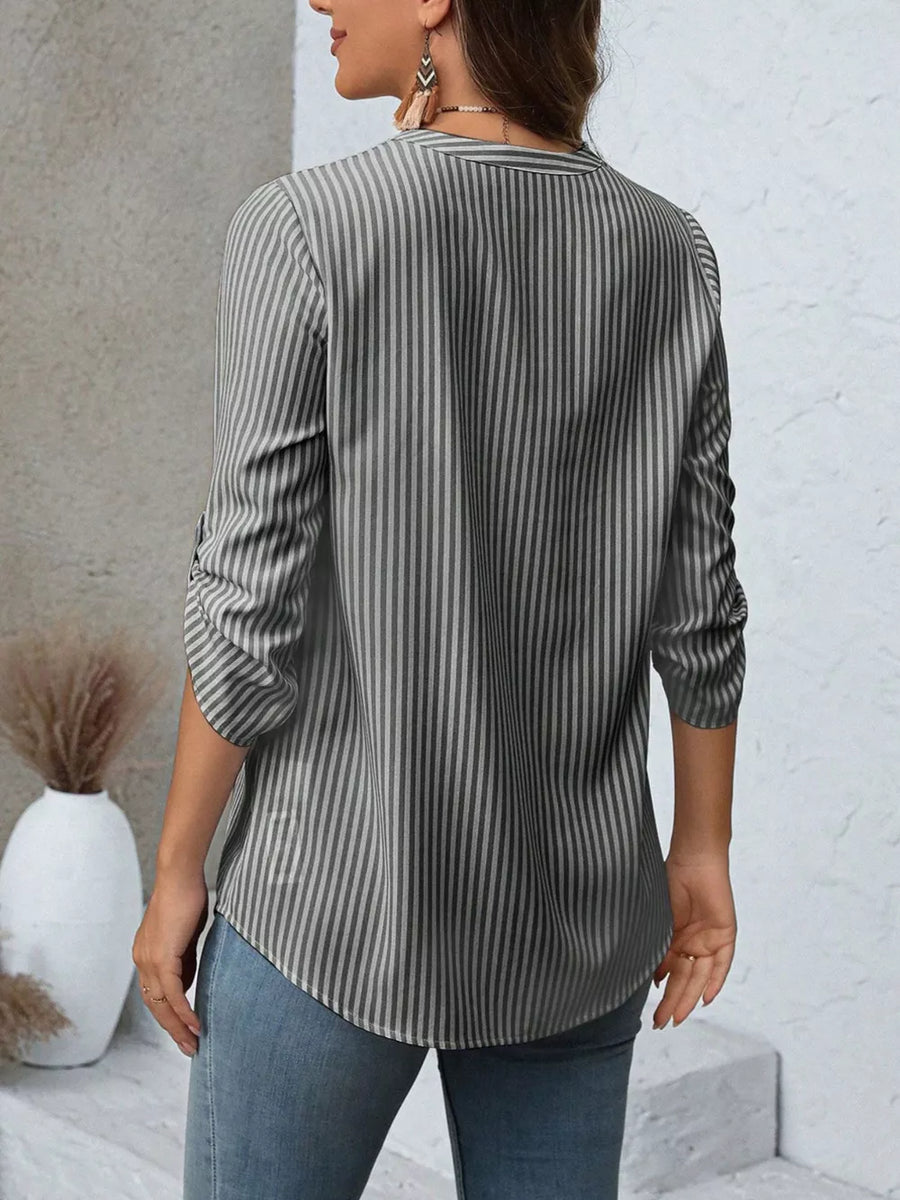 Vertical stripe V-neck blouse with roll-up sleeves in dark blue bar.