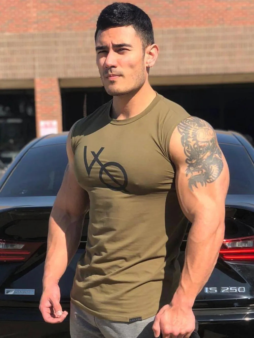 Olive graphic muscle tank top with crew neck and sleeveless cut.