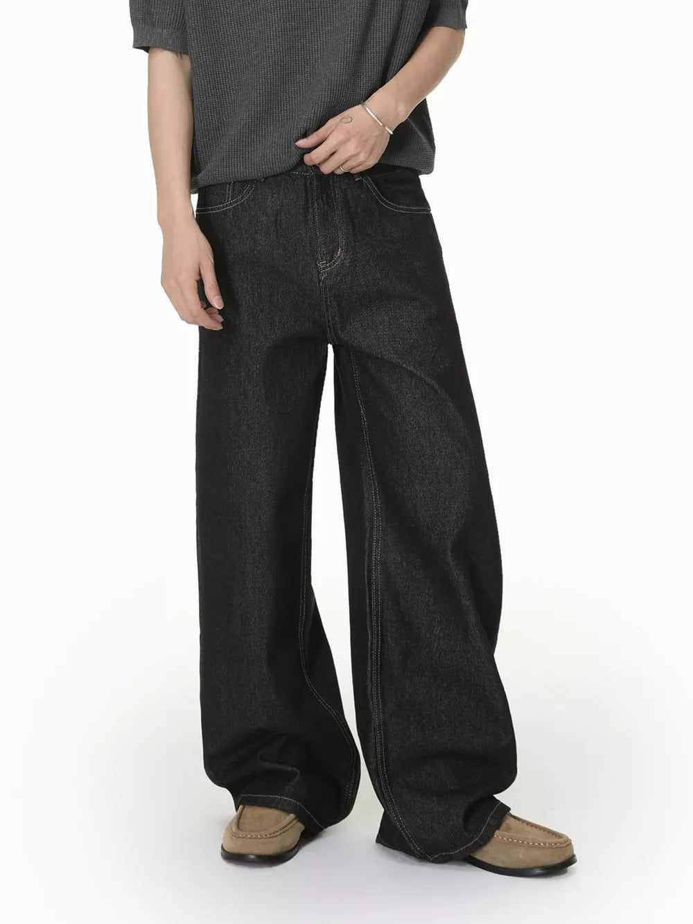 Relaxed fit dark wash wide-leg jeans with pockets and contrast stitching.