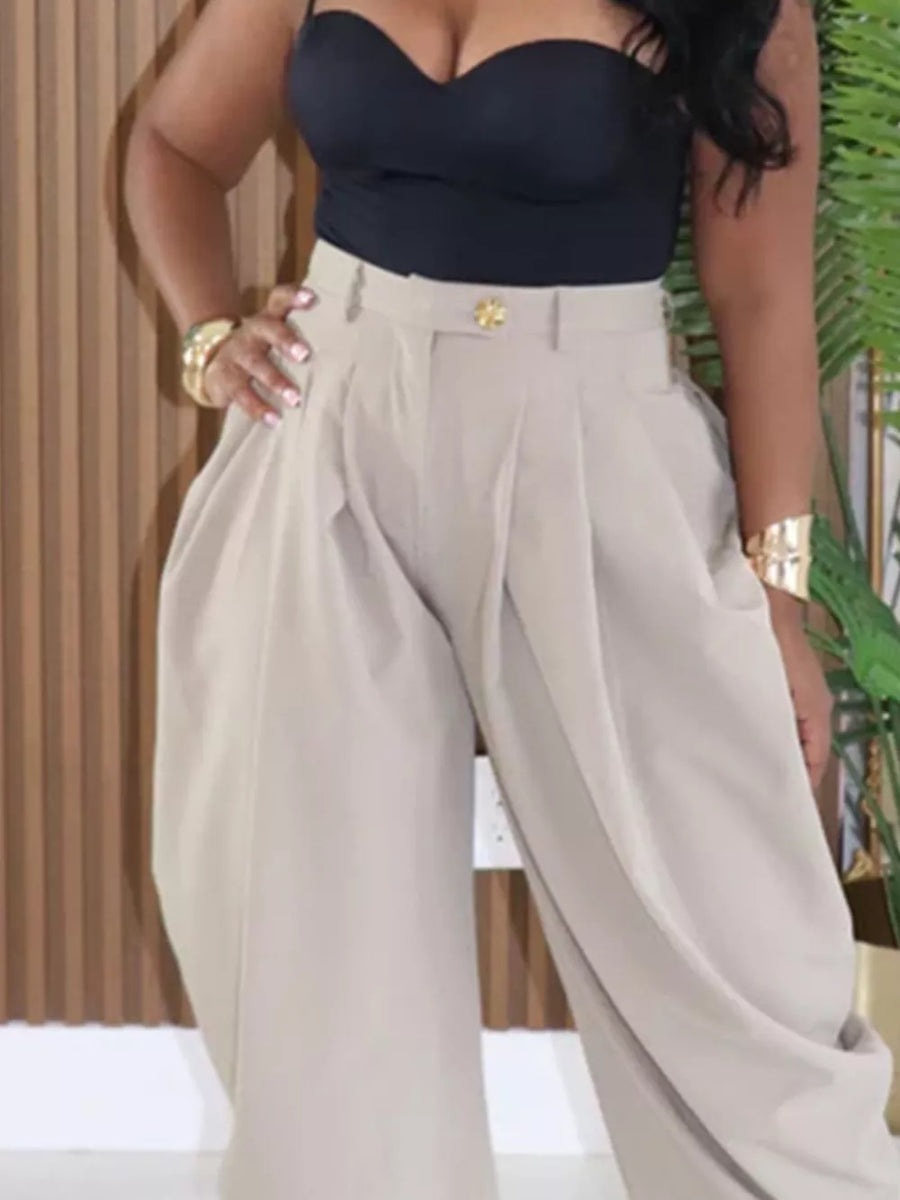 Light Khaki high-waisted pants with sculptural pleats and a gold button detail.