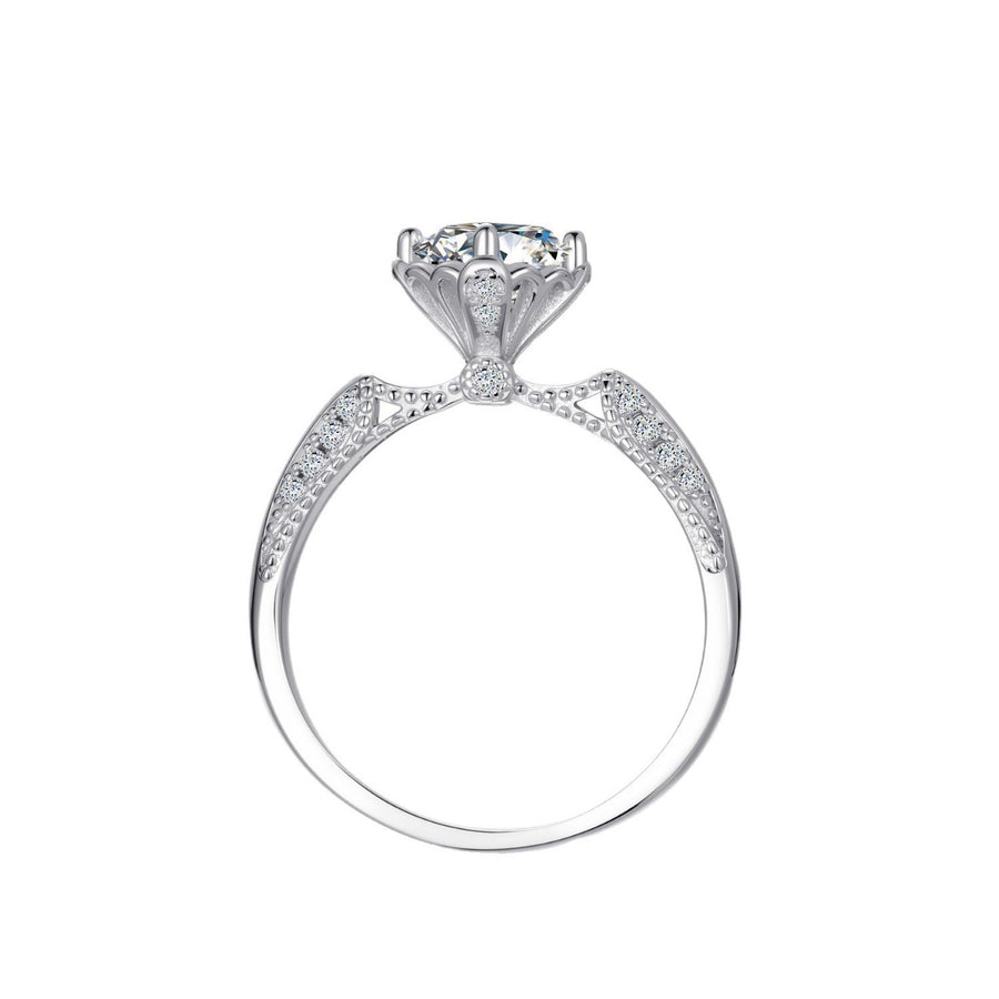 Moissanite sterling silver ring with diamond accents and intricate detailing.