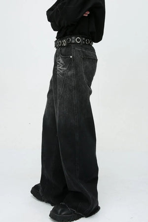 Faded panel wide-leg jeans in dark denim with distressed detailing and a raw hem.