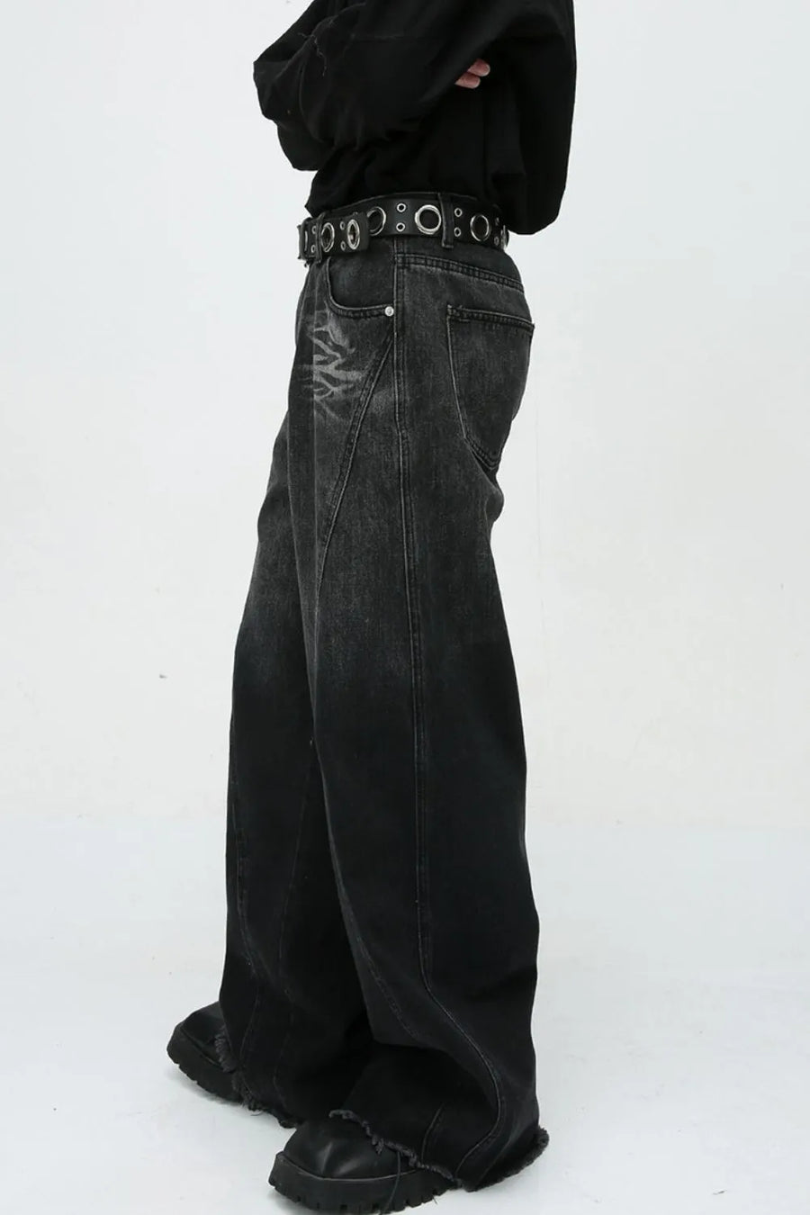 Faded panel wide-leg jeans in dark denim with distressed detailing and a raw hem.