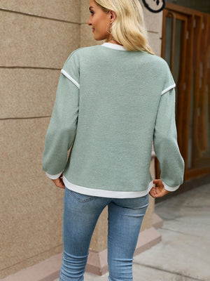 100% polyester Care instructions: Machine wash cold v-neck sweater in Black with relaxed silhouette
