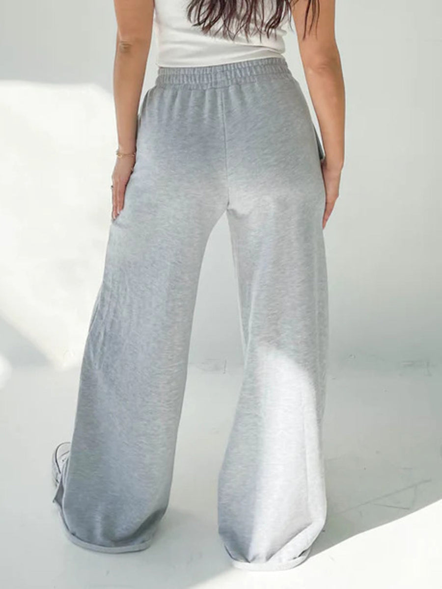 Wide-leg lounge pants in light gray with an elastic waistband and cuffed hems.