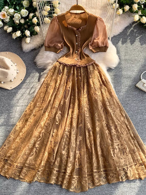 Brown lace-embellished puff sleeve dress with button front and square neckline.