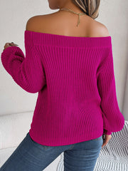 Open-knit off-shoulder sweater in cerise with voluminous sleeves and ribbed texture.