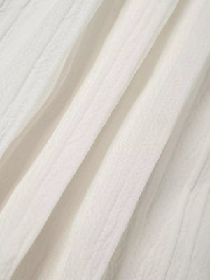 White tiered maxi skirt with textured fabric and elastic waistband detail
