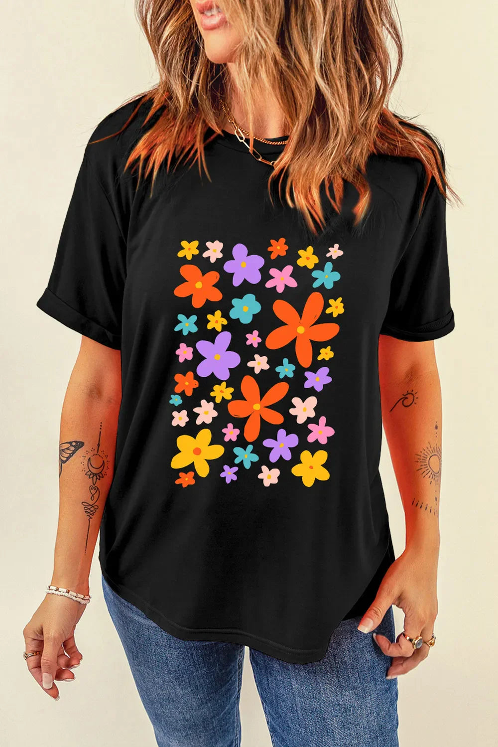 Black round neck tee with colorful bloom print and rolled sleeves