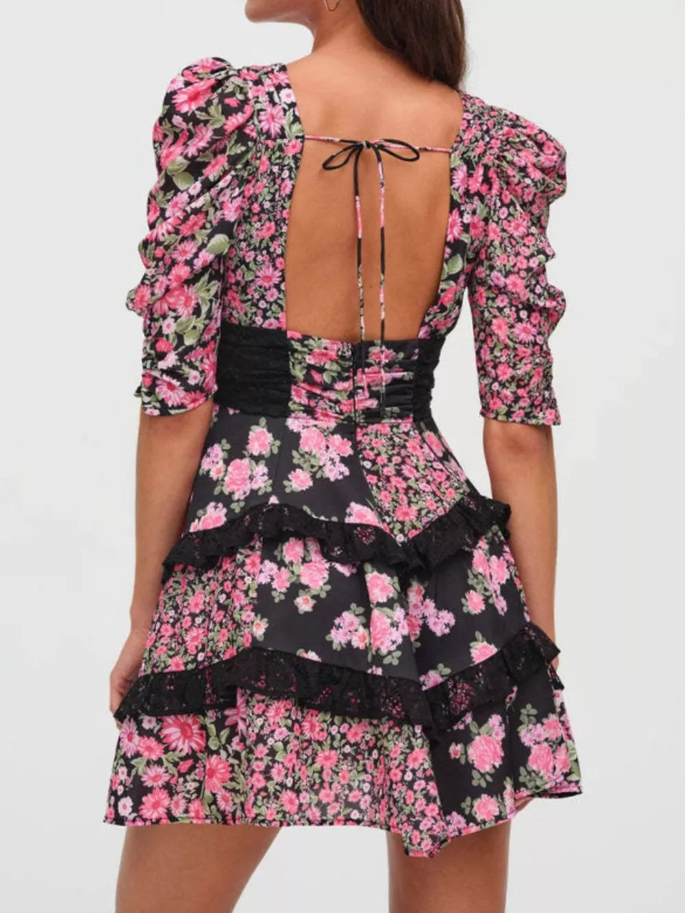 Ruched floral tie-front dress with black lace trim and tiered skirt.