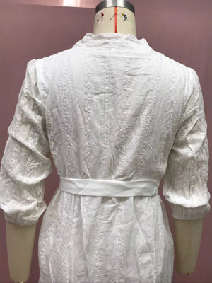 White embroidered dress with puff sleeves and a belted waist