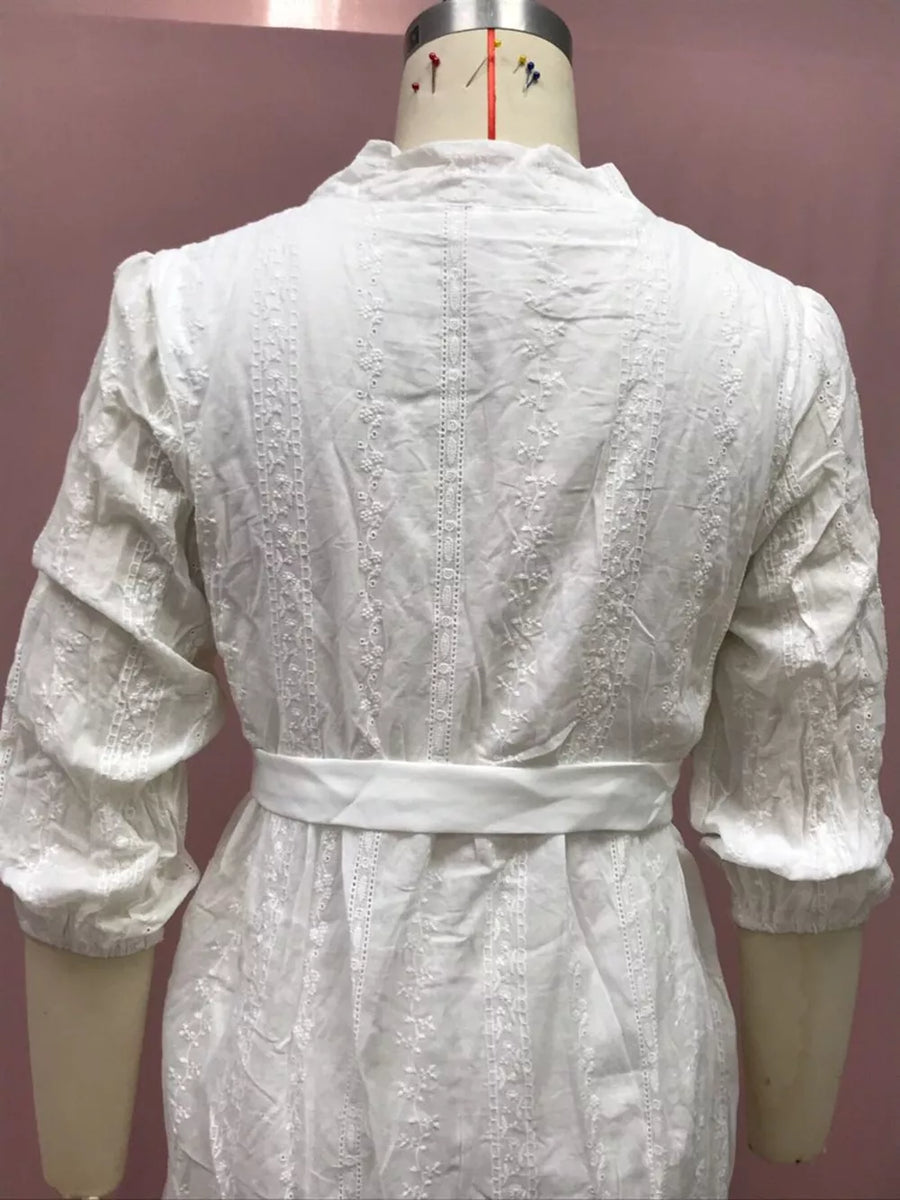 White embroidered dress with puff sleeves and a belted waist